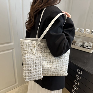Elegant tweed tote bag with matching pouch shown on shoulder for a chic minimalist look