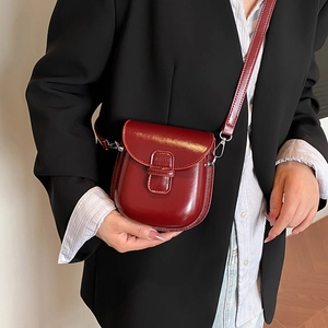 Elegant burgundy glossy leather horseshoe crossbody bag for women with silver hardware