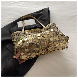 Detailed macro shot of shiny gold sequin bag texture on black stylish blazer