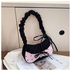 Detail of sweet y2k denim underarm bag featuring lace trim and heart metal pendant