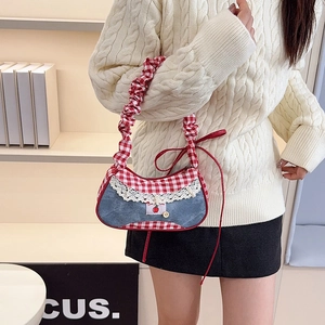 Denim underarm bag with red plaid, white lace trim and cherry patch detail