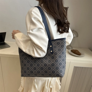 Navy blue monogram tote bag with leather straps and spacious interior for women