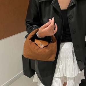 Minimalist caramel brown suede dumpling bag for women with sleek metal snap closure