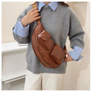 Detail of vintage brown PU leather crossbody bag with dual magnetic flap pockets on model