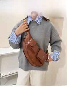 Detailed view of brown PU leather crossbody bag with multiple pockets and woven strap