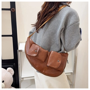 Brown PU leather chest bag detail showing vintage design with small front pockets and buckles