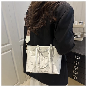Detail of white tote bag with rabbit print and vintage geometric shoulder strap