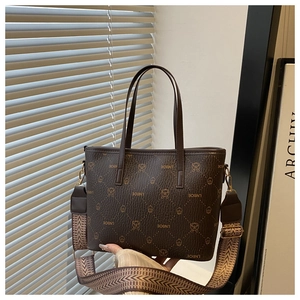 Close-up of brown bear pattern tote bag with wide geometric fabric shoulder strap