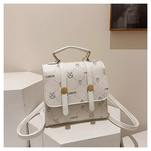 Detailed view of white mini backpack featuring cute animal prints and golden hardware accents