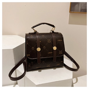 Detail of dark brown lychee leather backpack with cartoon rabbit monogram and gold hardware