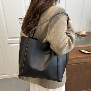 Classic large black leather tote bag with long straps for chic office and urban casual style