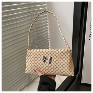 Chic cream underarm bag with leopard pattern and metallic silver bow detail