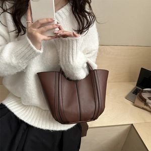 Minimalist brown PU leather bucket bag with vertical stitching and top handle