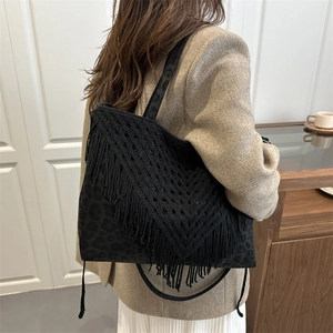 Chic black crochet tote bag with fringe details and leopard texture for 2025 fashion