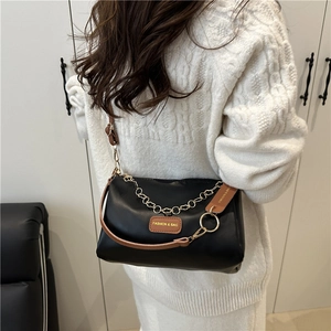 Fashionable black leather crossbody pillow bag with gold chain strap for women