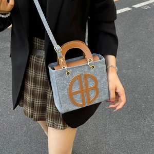 Chic grey felt tote bag with brown handles and HB logo for 2025 autumn casual fashion