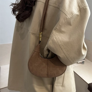 Sac demi-lune en daim marron avec fermoir métallique et bandoulière fine