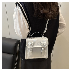 Silver metallic backpack with bow accents shown on model for size and fit