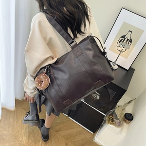 Large brown PU leather shoulder bag with donut charm for minimalist commute