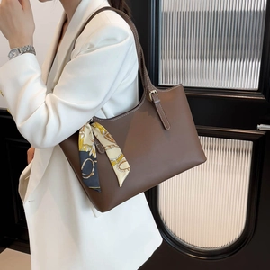 Minimalist brown vintage tote bag with floral silk scarf on model in white suit