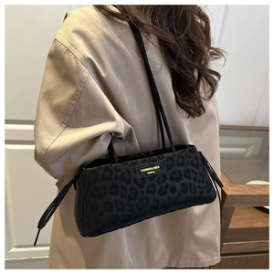 Detail of vintage leopard print tote bag with adjustable drawstring and leather brand logo