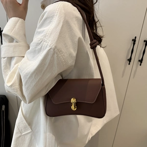 Brown matte leather underarm baguette bag with gold buckle and knotted shoulder strap