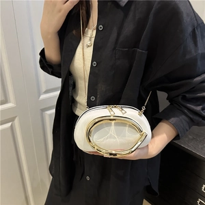 White semi-circle pillow bag with large gold U-shaped handle and chain strap