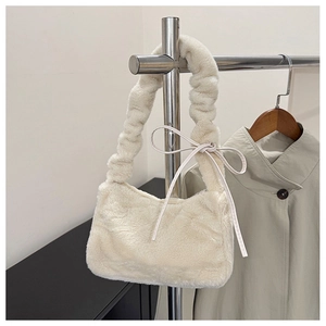 Detail of off-white faux fur shoulder bag featuring pleated cloud strap and bow accents