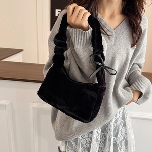 Fashionable black faux fur underarm bag with ribbon bow and gathered handle
