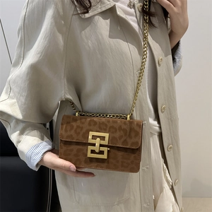 Vintage leopard print square crossbody bag with gold chain strap shown on a model