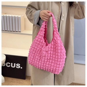 Detail of hot pink bubble textured tote bag showing 3D waffle fabric and soft shoulder strap