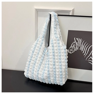 Detailed macro view of light blue and white striped bubble texture canvas tote bag