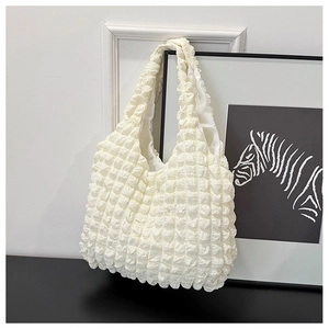 Close-up of white pleated popcorn texture fabric on a large minimalist shoulder tote bag