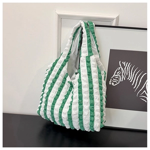 Detail of green and white striped tote bag with 3D bubble textured fabric finish