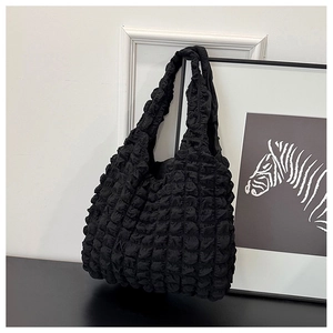 Detail shot of black popcorn texture canvas tote bag with 3D pleated fabric design