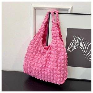 Close-up of pink bubble textured tote bag with elastic pleated fabric for women