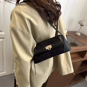 French-style black baguette shoulder bag with matte leather and golden D-ring buckle