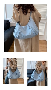 Detail view of large light blue nylon crescent bag with seamless shoulder strap
