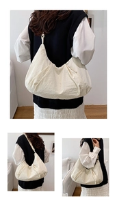 Detail view of large crescent bag showing ruffled texture and off-white nylon fabric