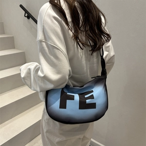 Minimalist gradient blue crossbody bag with FE print and adjustable strap on white hoodie
