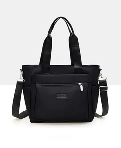 Detail view of large nylon shoulder bag with multiple pockets and adjustable strap