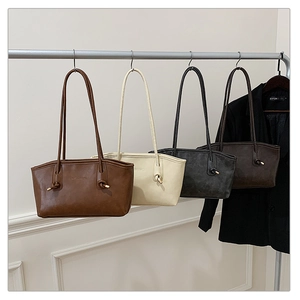 Detail of four retro shoulder bags in brown, beige, grey, and dark coffee finishes
