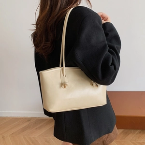Minimalist beige leather shoulder bag with unique knot design for women's daily commute