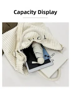 Interior view showing large capacity of the white corduroy tote bag with daily items