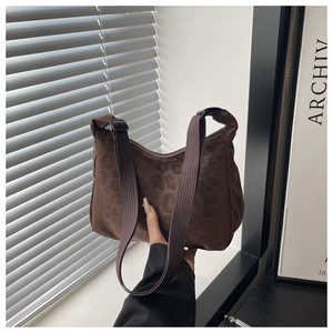Detail of leopard print nylon bag with adjustable webbing strap in a minimalist setting