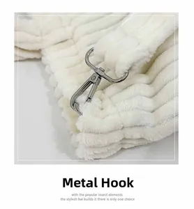 Macro detail of the high-quality silver metal hardware hook on white corduroy tote bag