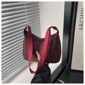 Detail of burgundy leopard pattern nylon fabric and wide shoulder strap on tote bag