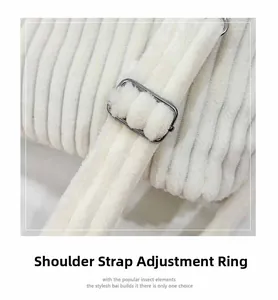 Detail of silver metal shoulder strap adjustment buckle on off-white corduroy tote bag