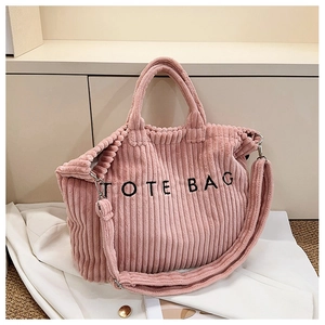 Detail shot of pink corduroy tote bag with TOTE BAG embroidery and adjustable strap