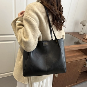 Classic black vintage faux leather tote bag for women with gold logo and rivet detail
